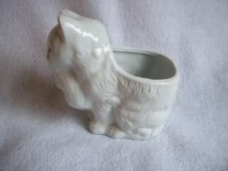   / ceramic planter of a mother cat carrying her kitten in her mouth