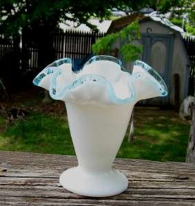 This is a nice little Fenton glass blue crest on white Vase  Damage 