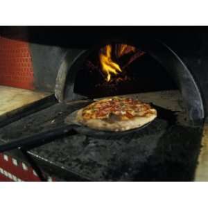  Pizza Comes Out of a Brick Oven in a Restaurant in Rome 